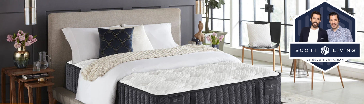 Closeup shot of a Scott Living mattress in a nicely decorated room with the Scott LIving logo on the right hand side of the image